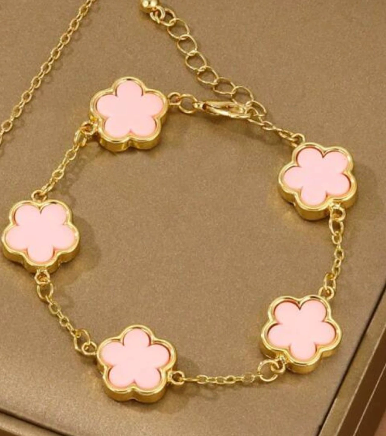 Gold-tone bracelet with pink flower charms