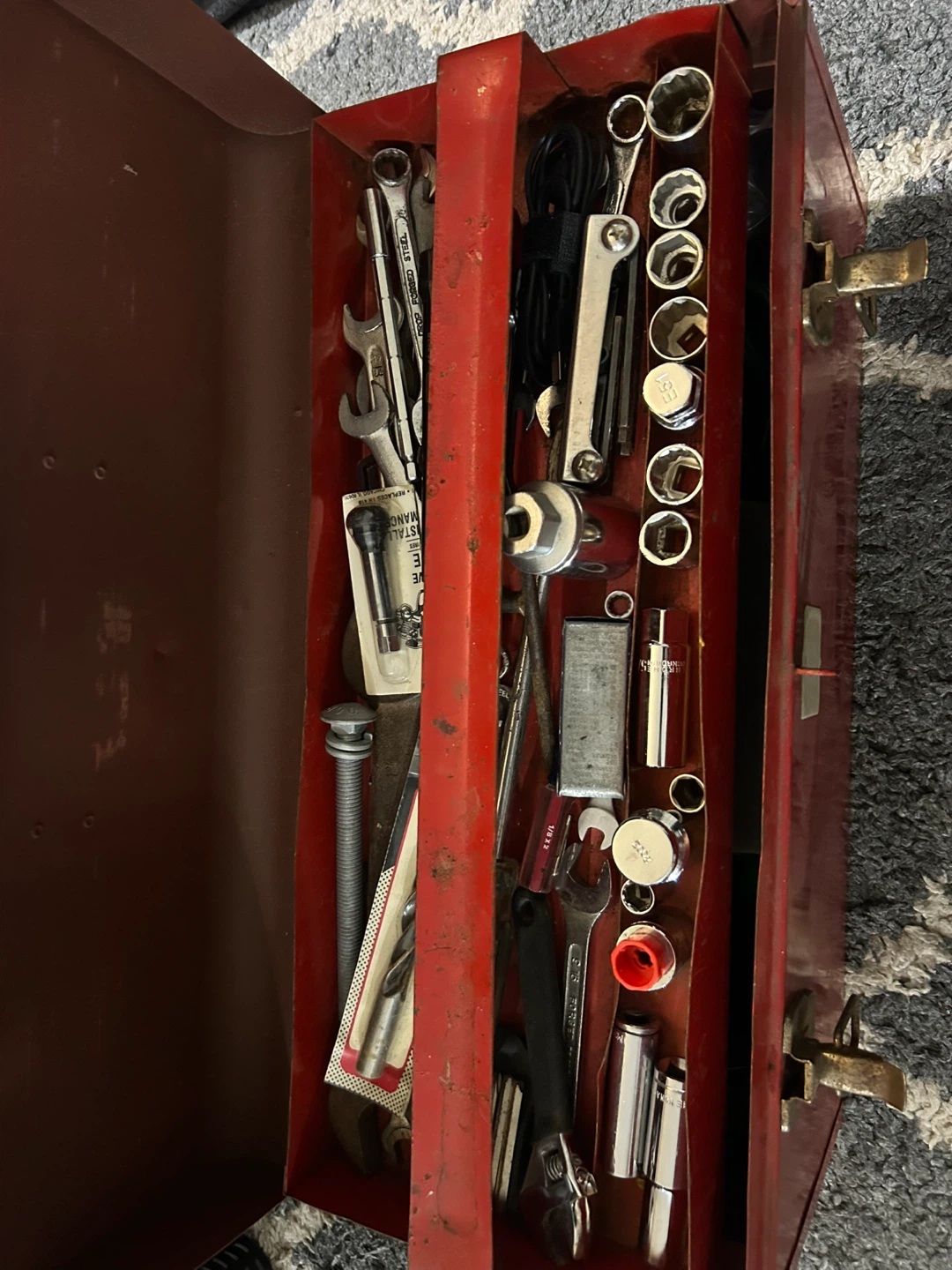 Red Metal Toolbox with Assorted Tools
