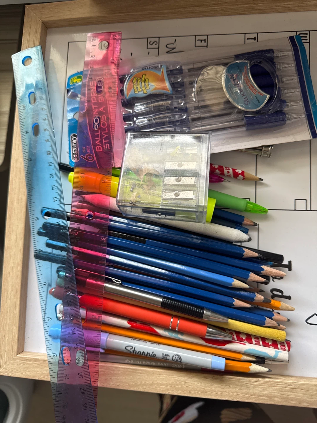 Assorted Pens, Pencils, Rulers, and Sharpener