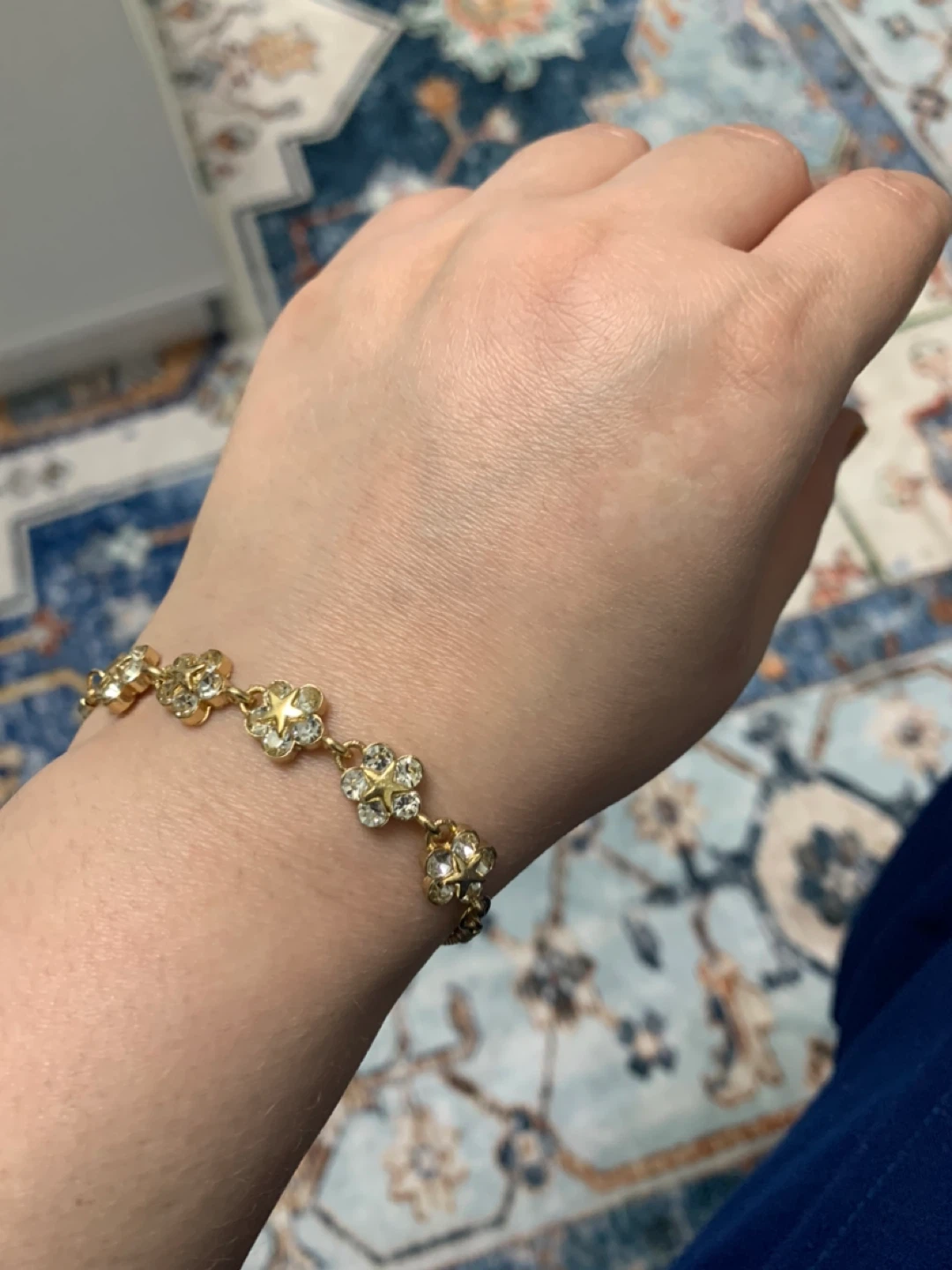 Gold-tone bracelet with crystal flower charms