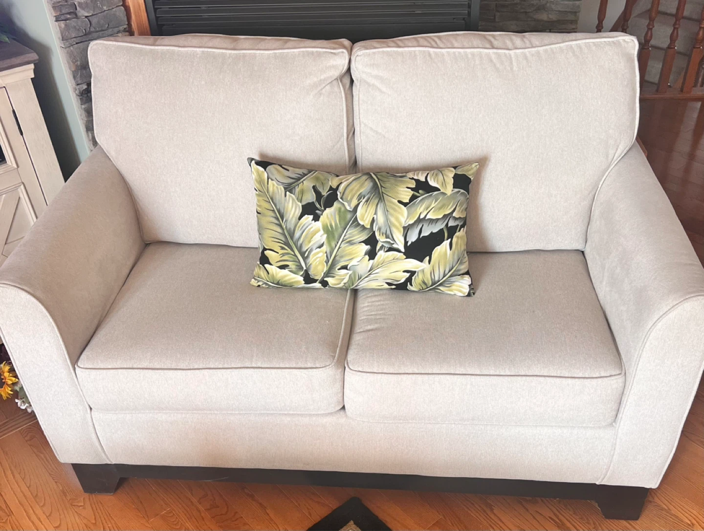 Light Beige Loveseat with Tropical Accent Pillow
