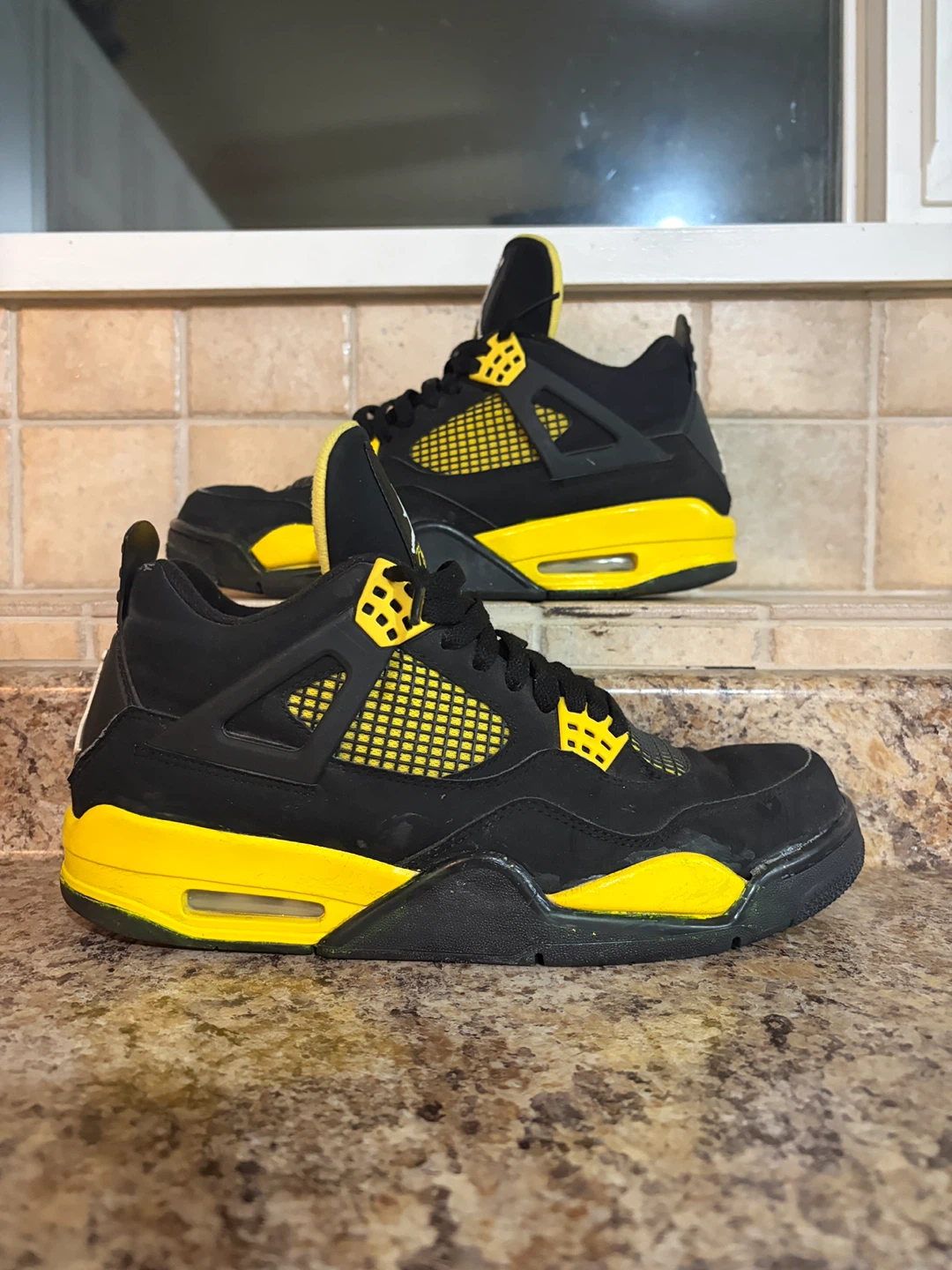 Air Jordan 4 "Lightning" Black/Tour Yellow Sneakers