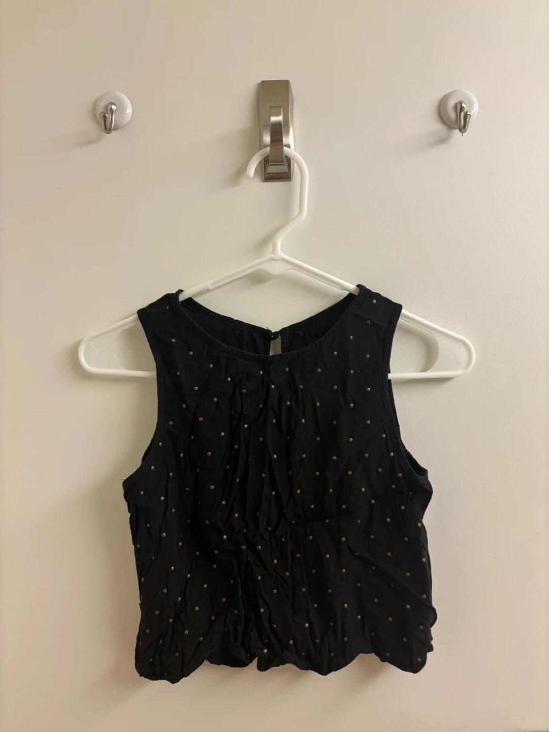 Black sleeveless top with gold stud detail