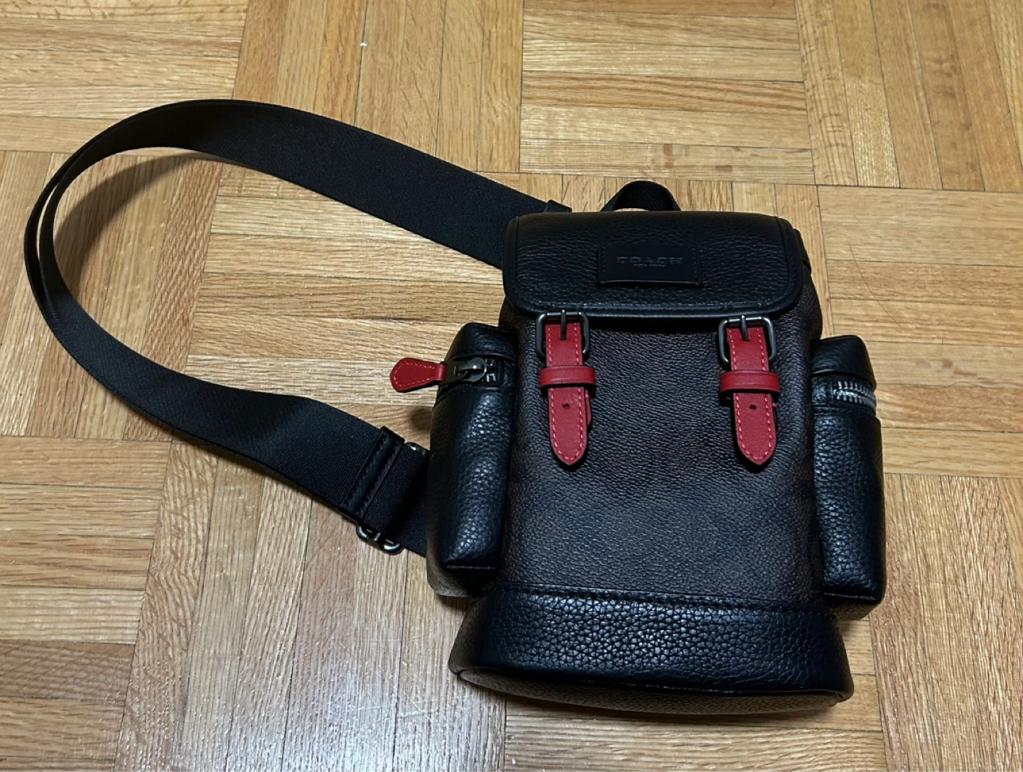 Coach Black Leather Sling Backpack with Red Accents