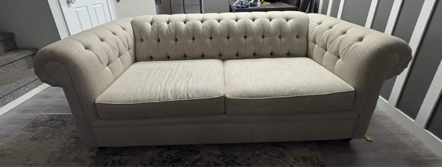 Cream Upholstered three seater sofa