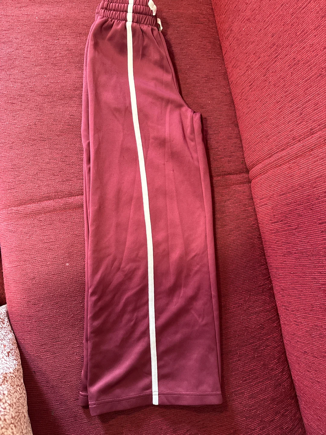 Maroon track pants with white stripe