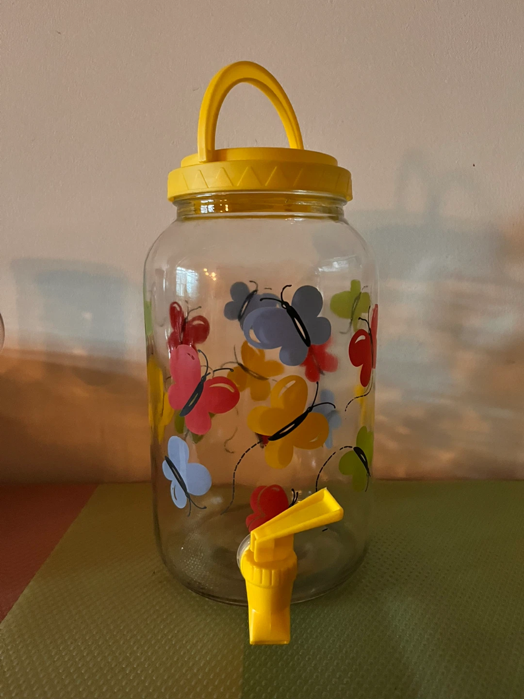 Glass Beverage Dispenser with Yellow Lid and Spigot
