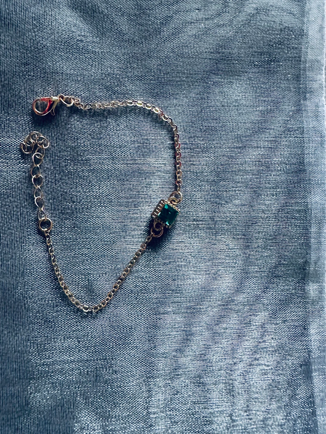 Gold-tone chain bracelet with green stone accent