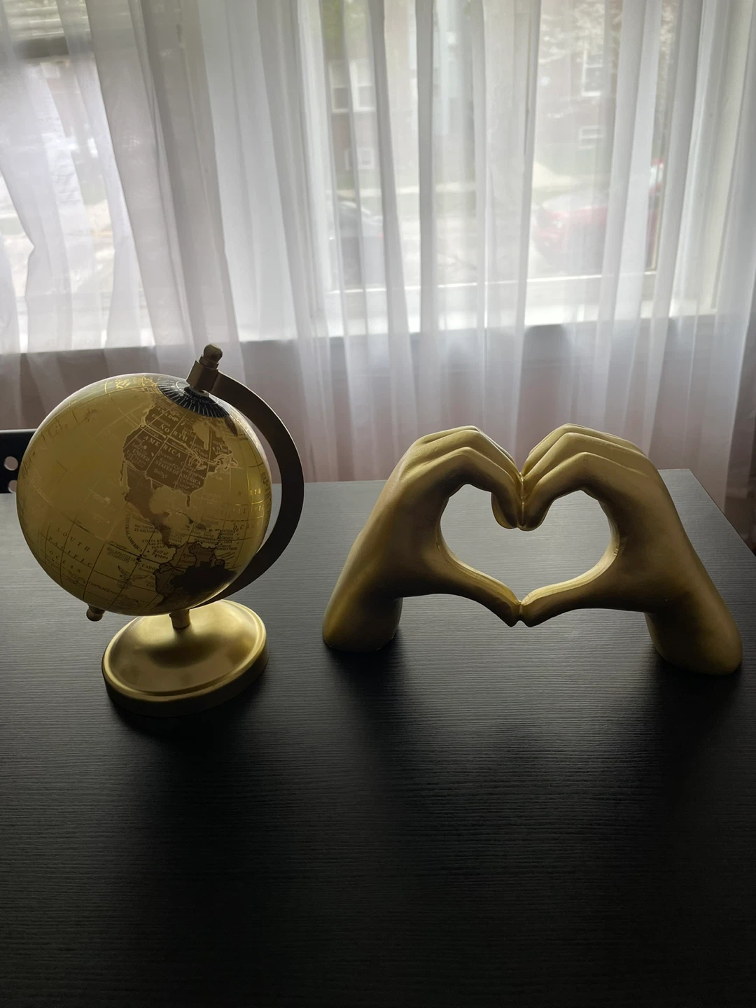 Gold globe and heart hands sculpture set