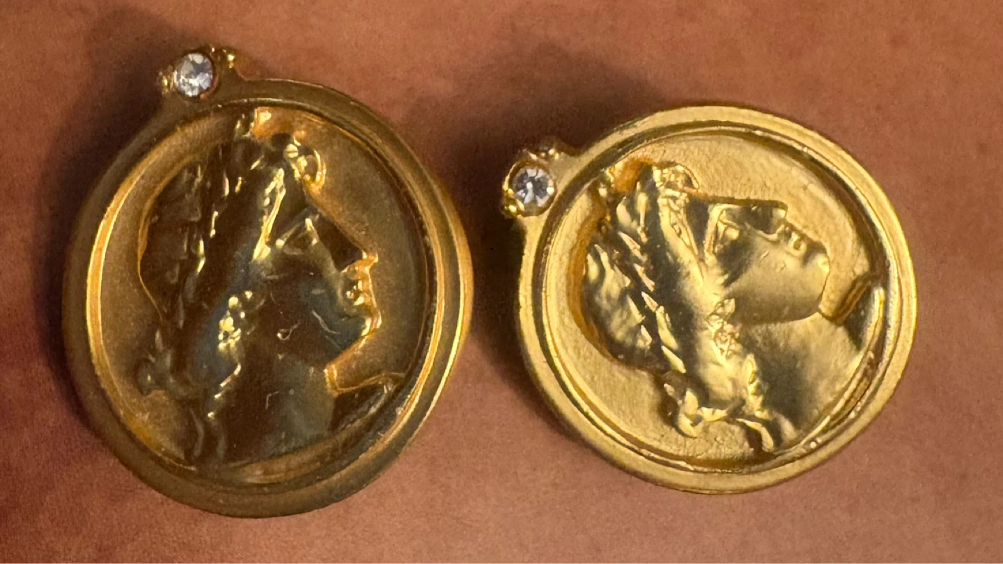 Gold tone medallion clip-on earrings with faux diamonds