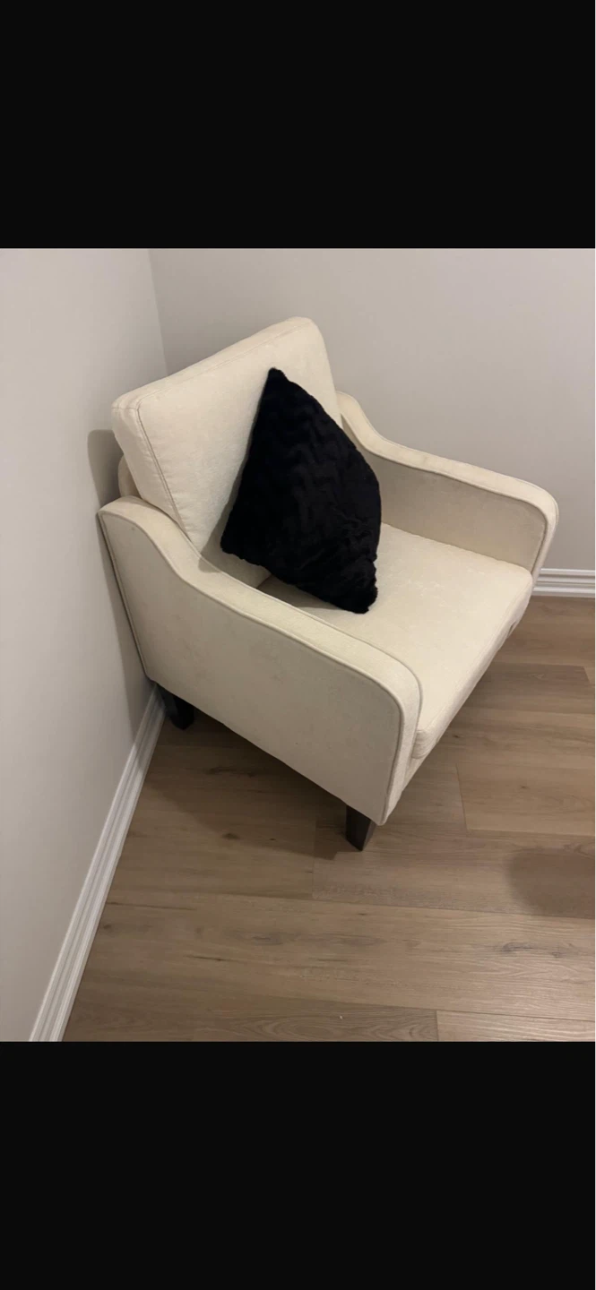 Cream Armchair with Black Throw Pillow