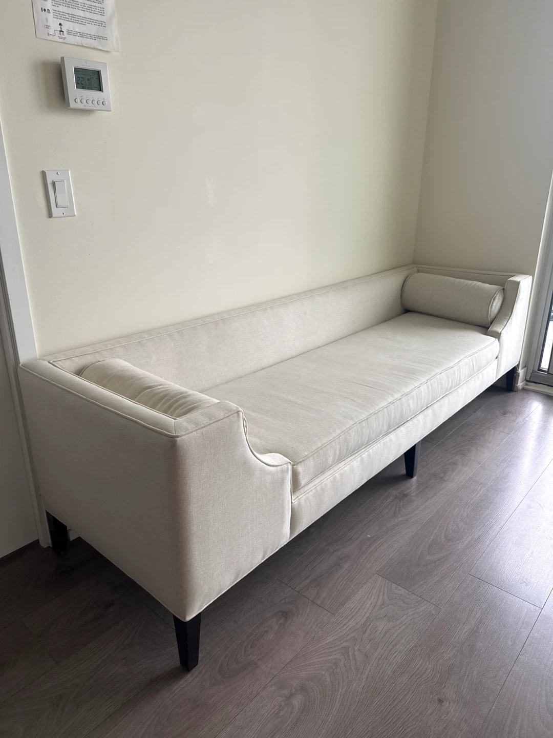 Cream coloured chaise lounge with bolster pillow