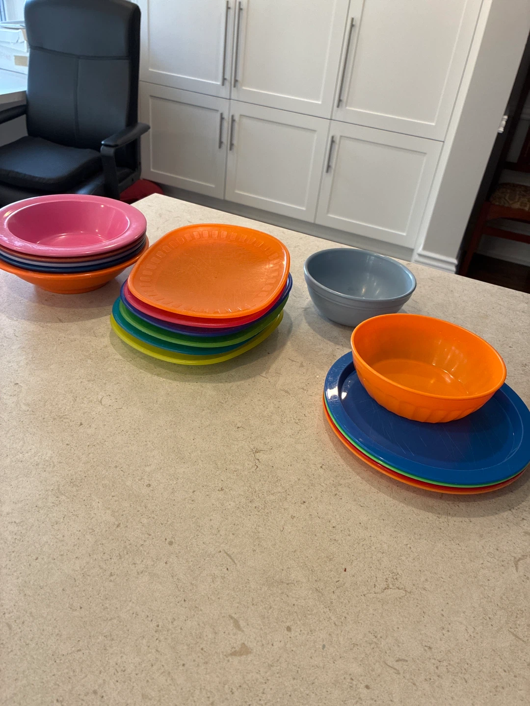 Assorted collection of colourful plastic bowls and plates