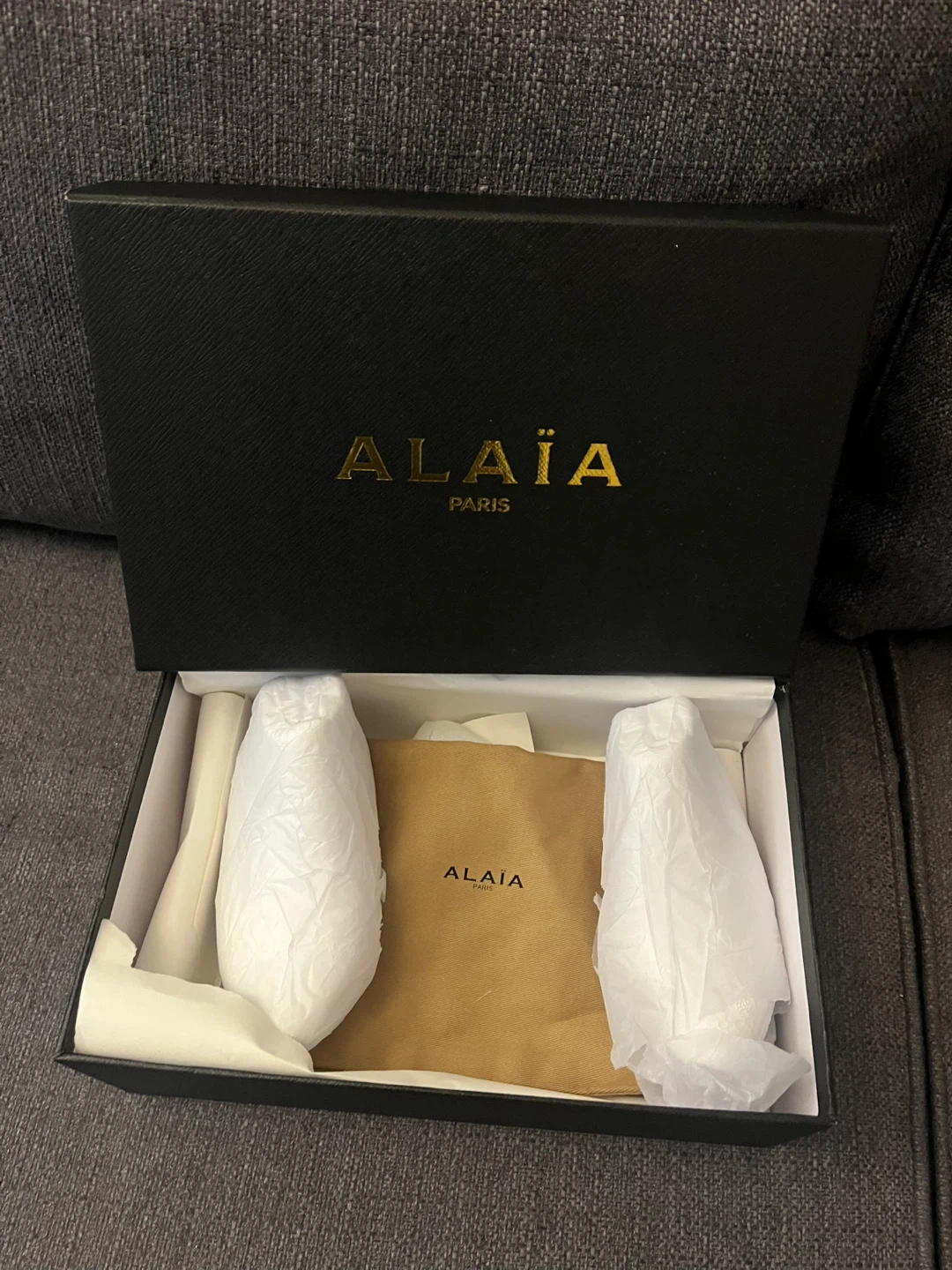 Empty shoe box with bags and other accessories