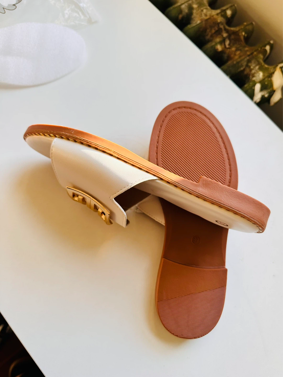 White slides with gold buckle