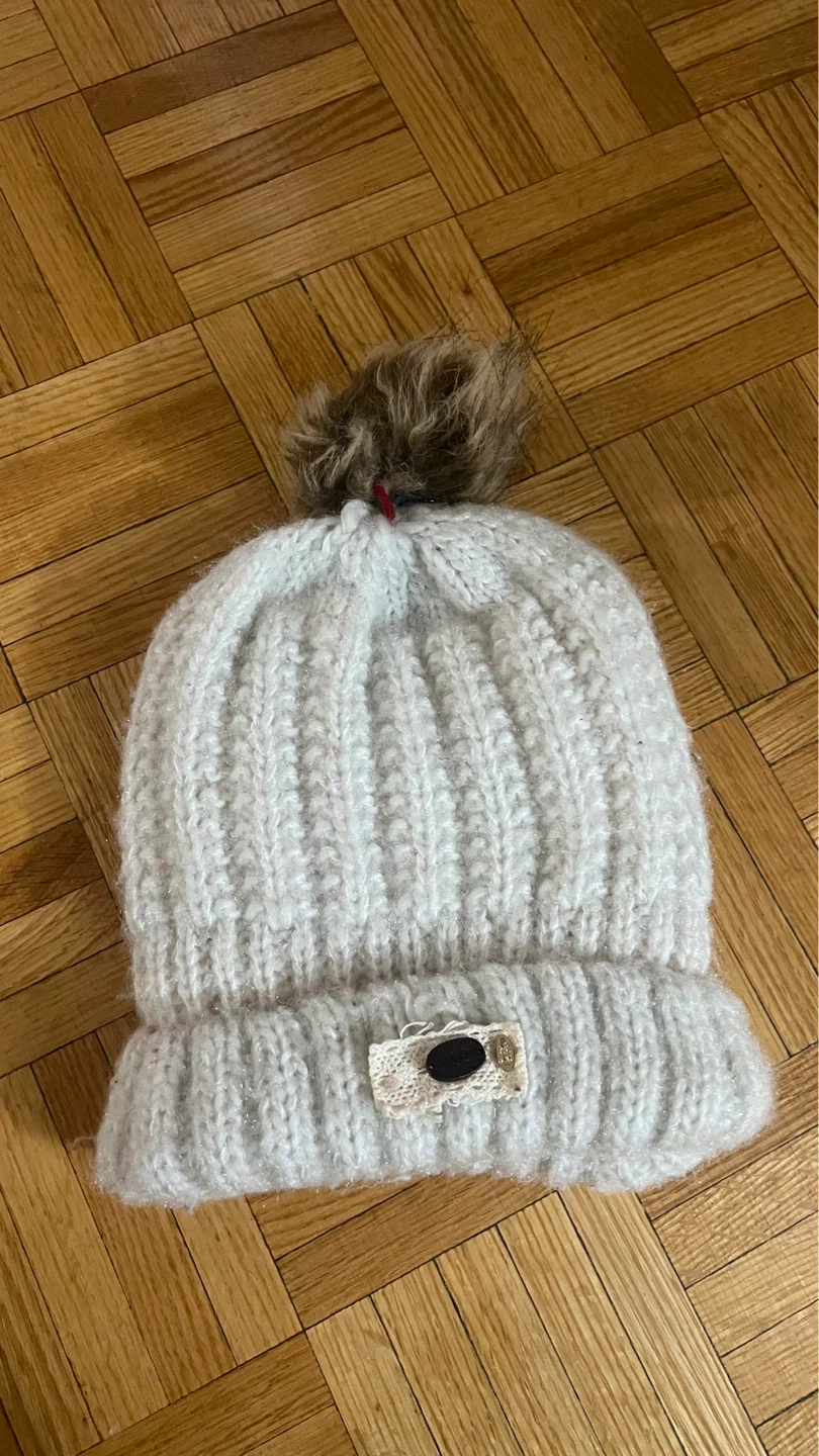 Cream color knitted beanie with pom-pom