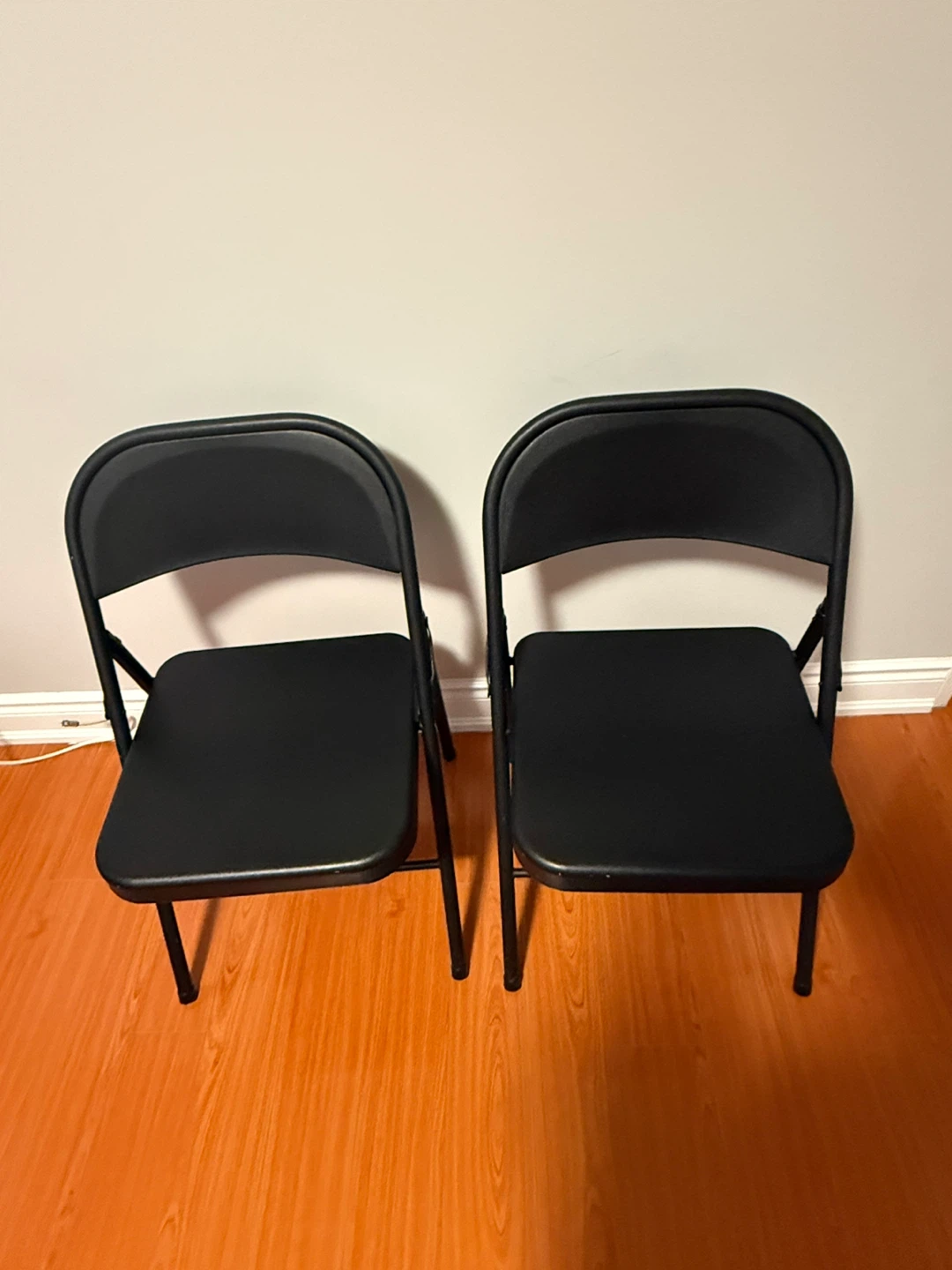 2 new black folding metal chairs