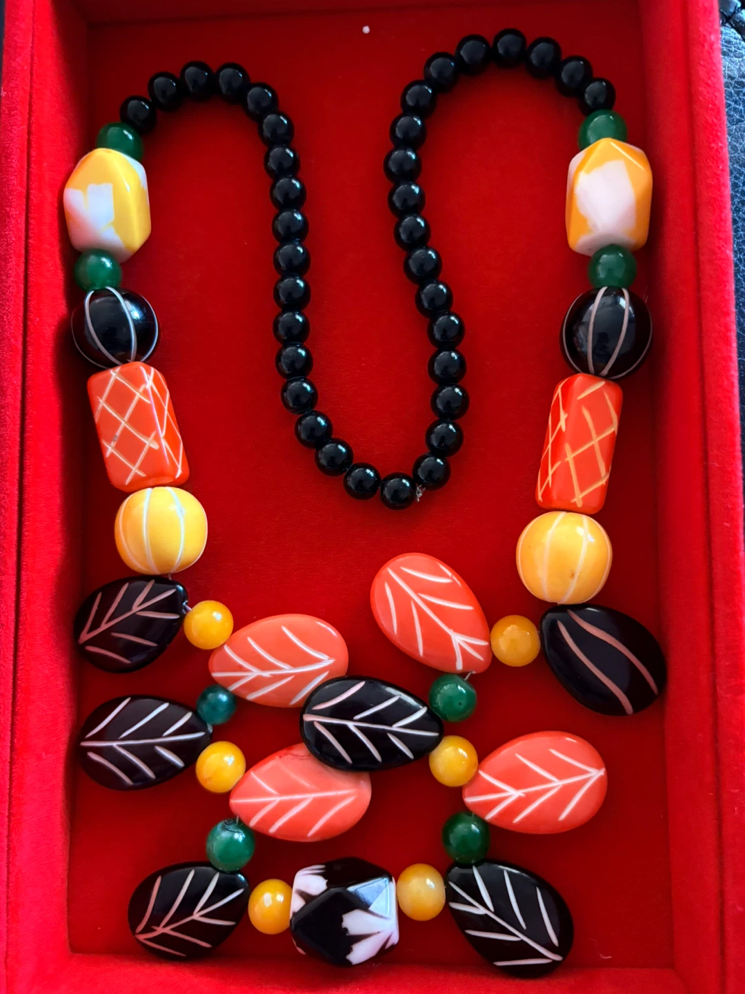 Beaded Necklace with Orange, Yellow, Black, and White Charms