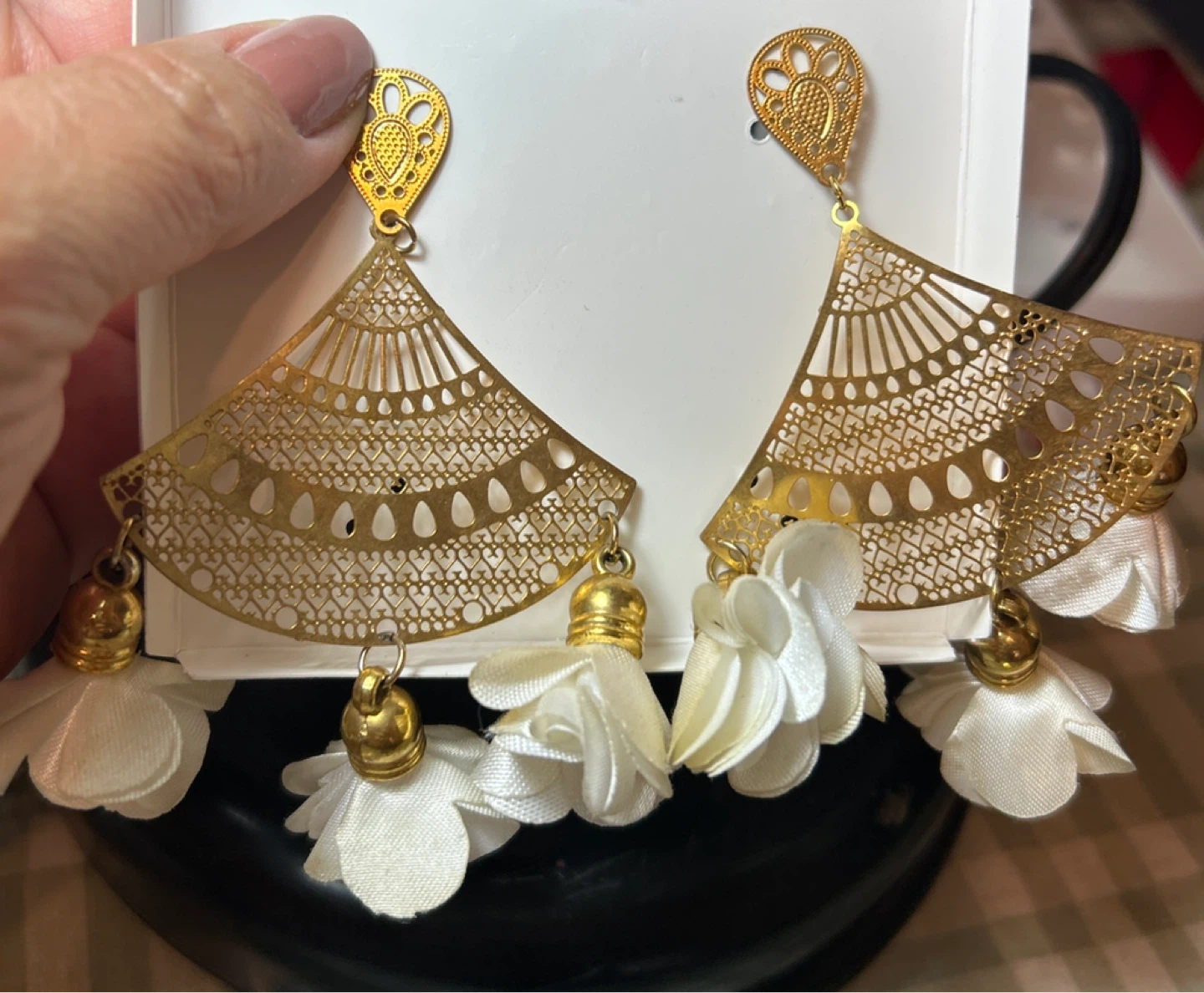 Gold tone fan dangle earrings with white tassels