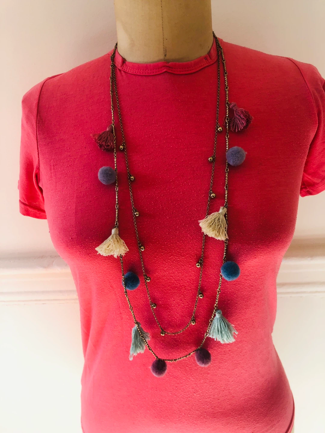 Long necklace with tassels and pom-poms
