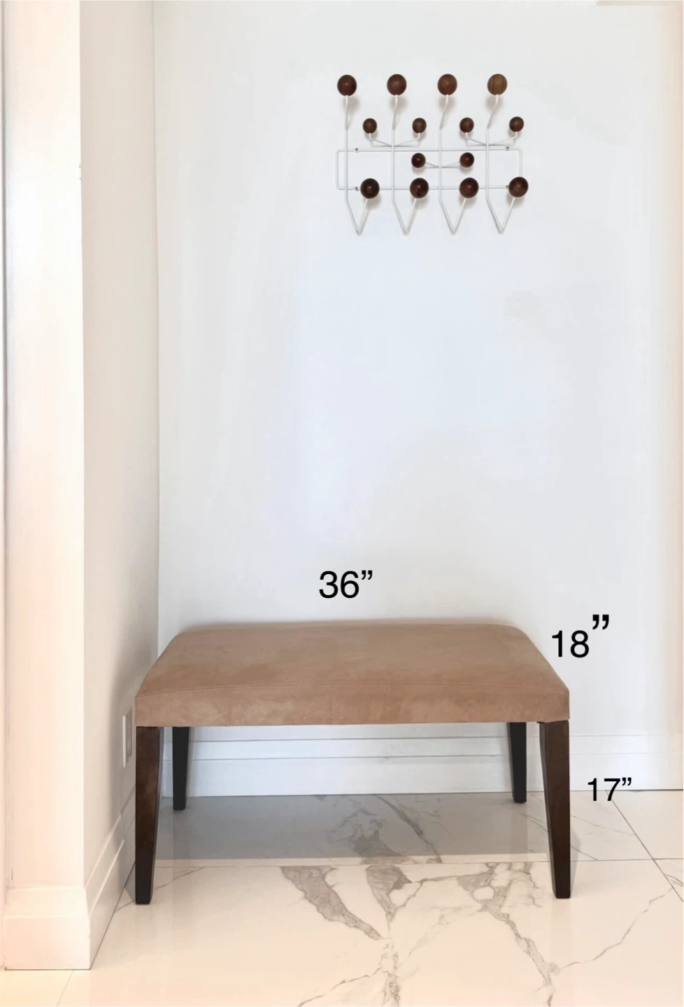 Neutral brown upholstered bench with dark wood legs.