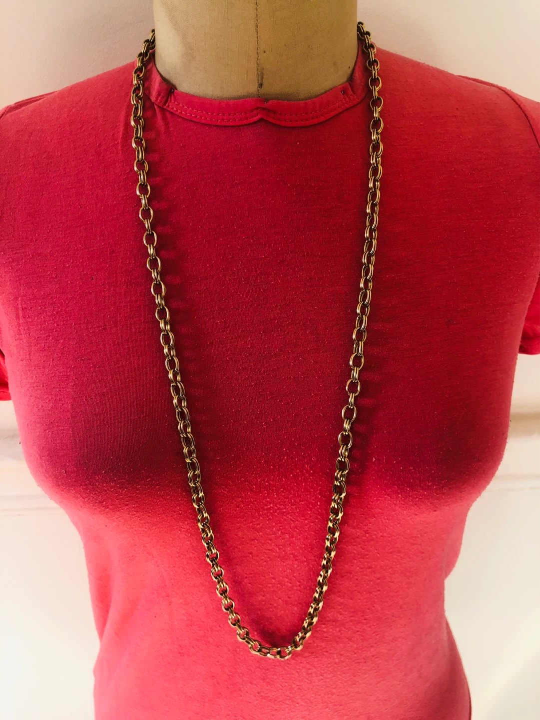 Gold tone long chain necklace with toggle clasp