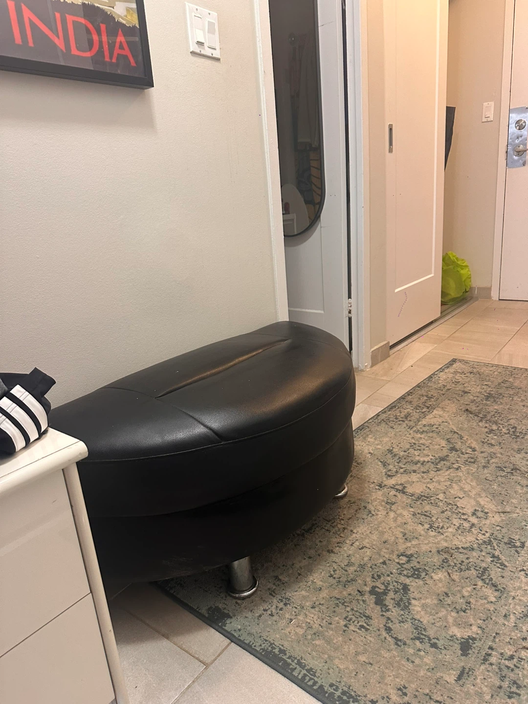 Black faux leather ottoman