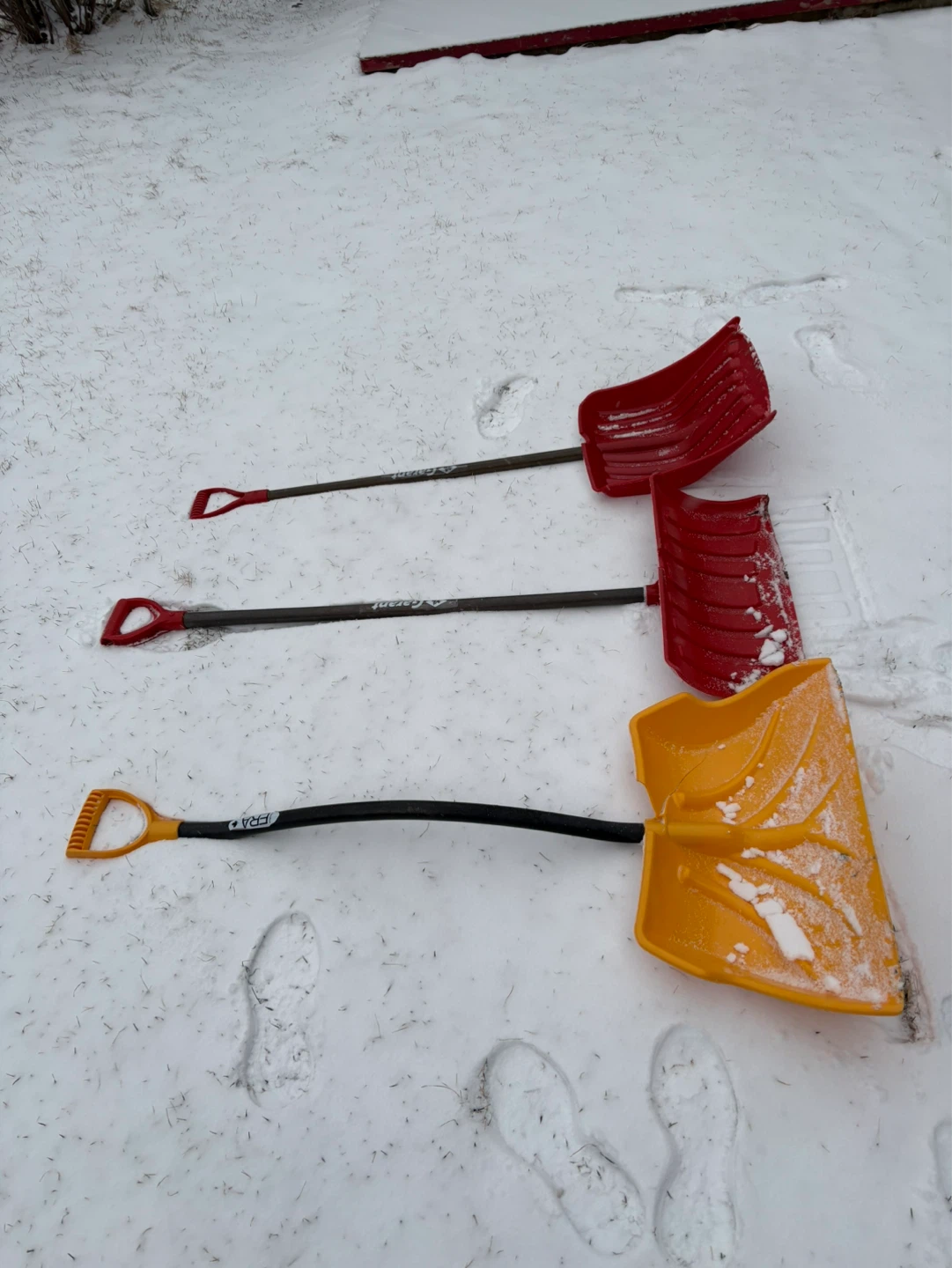 Red and Yellow Snow Shovels