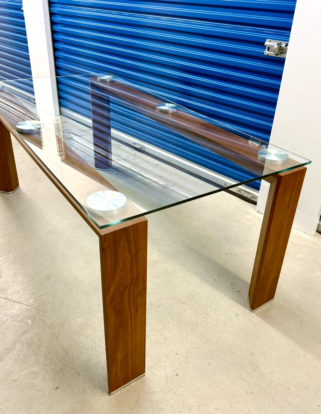 glass dining table with a glass top and solid wood base