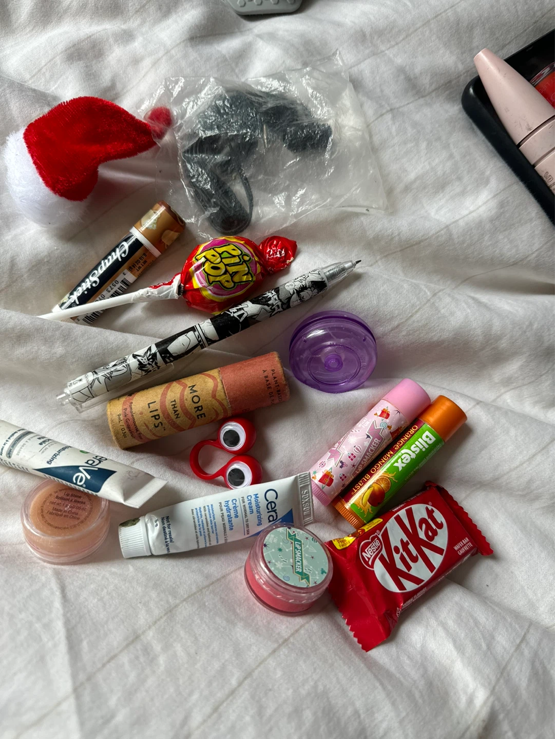 Assorted Lip Balms, Candy, and Small Items