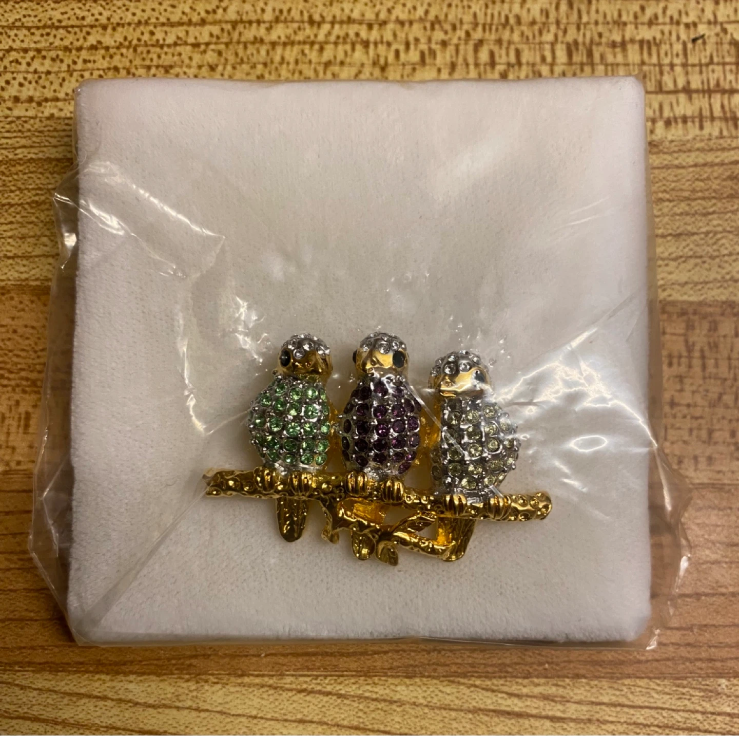 Brooch with three jewelled birds on a branch