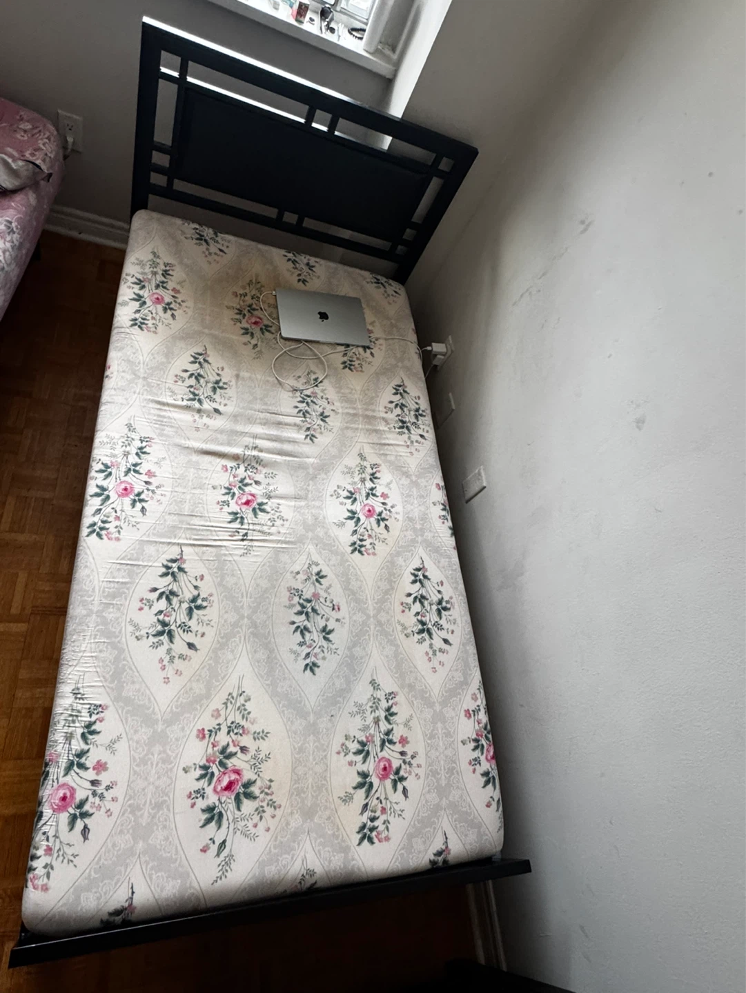 Black Metal Bed Frame with Floral Mattress