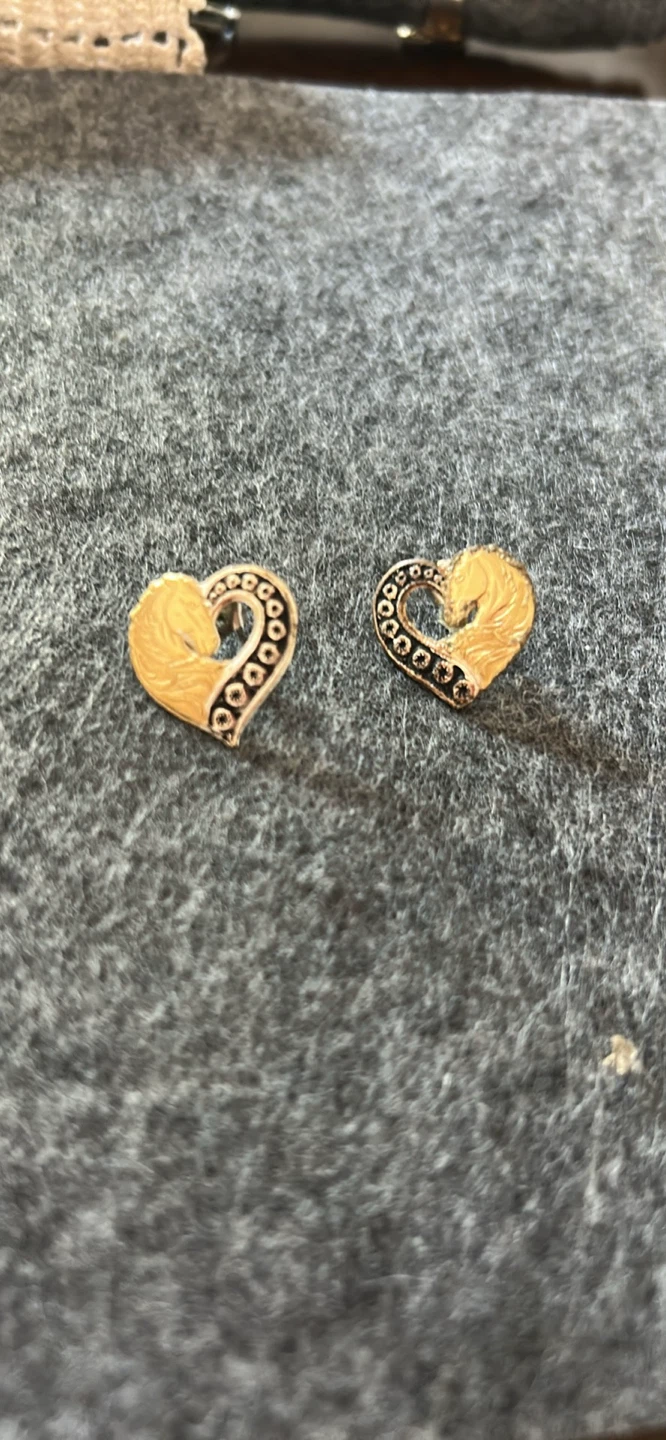 Gold heart-shaped earrings with horse detail