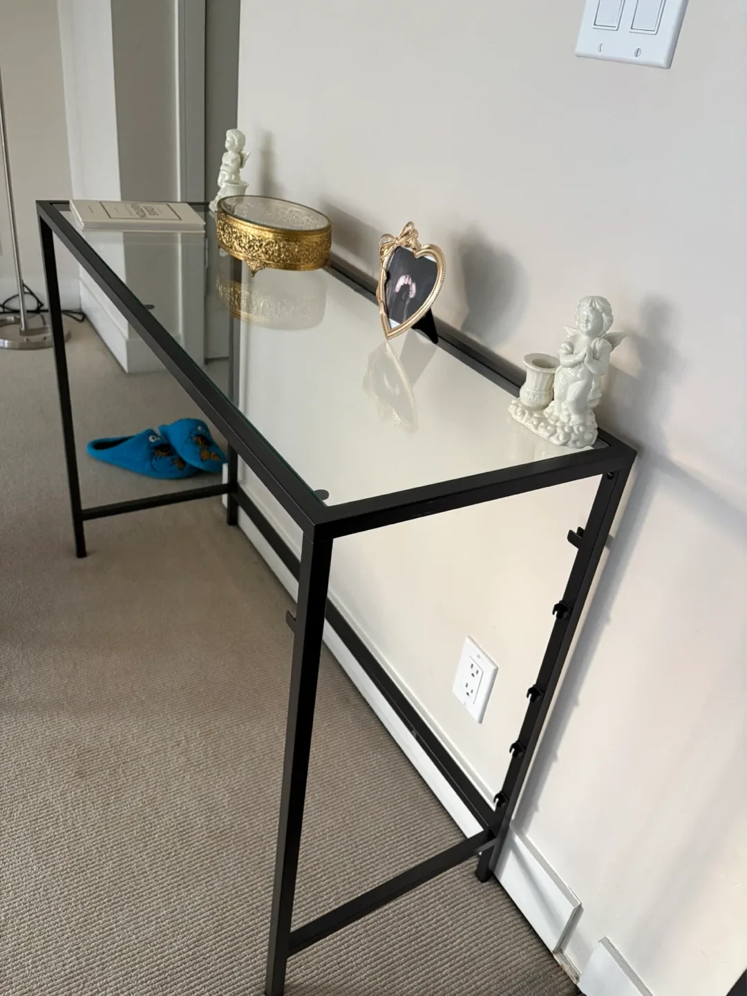 Glass top table with black metal frame