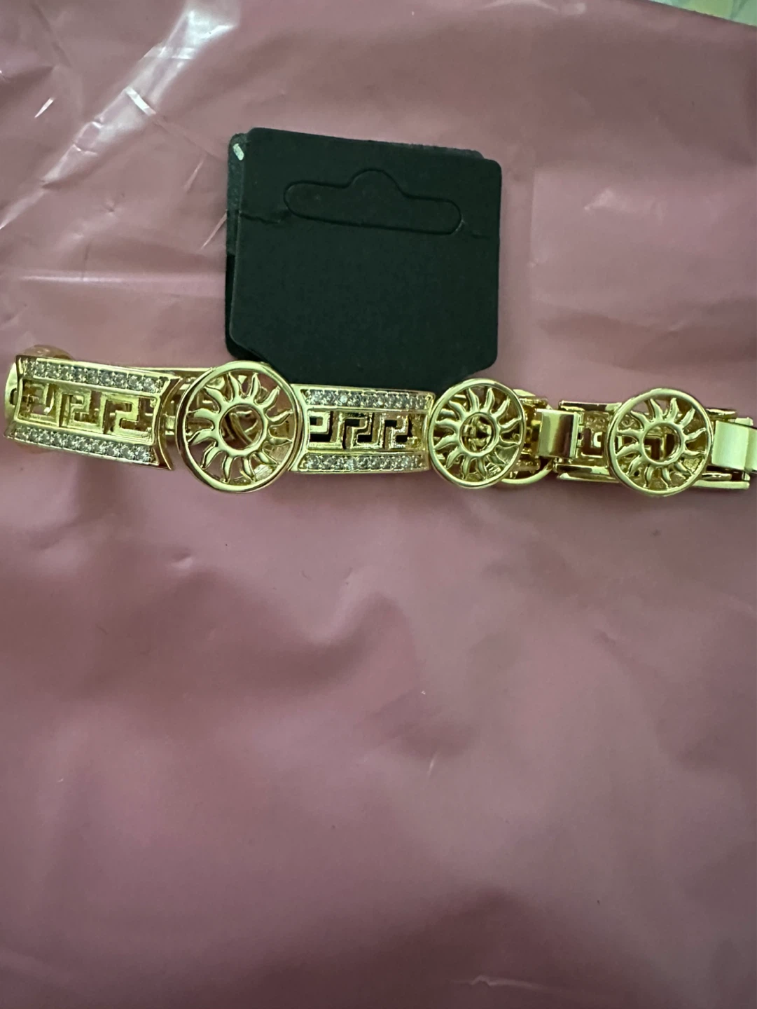 Gold laminated bracelet with sun and Greek key design