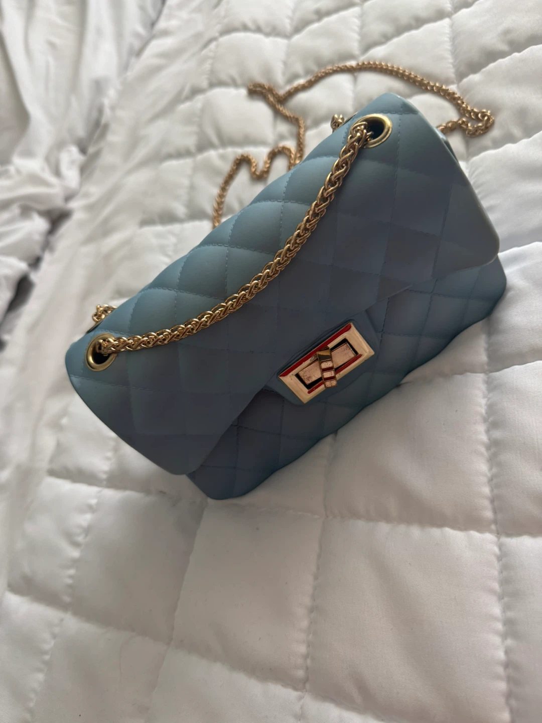 Two purses: blue quilted and black faux leather