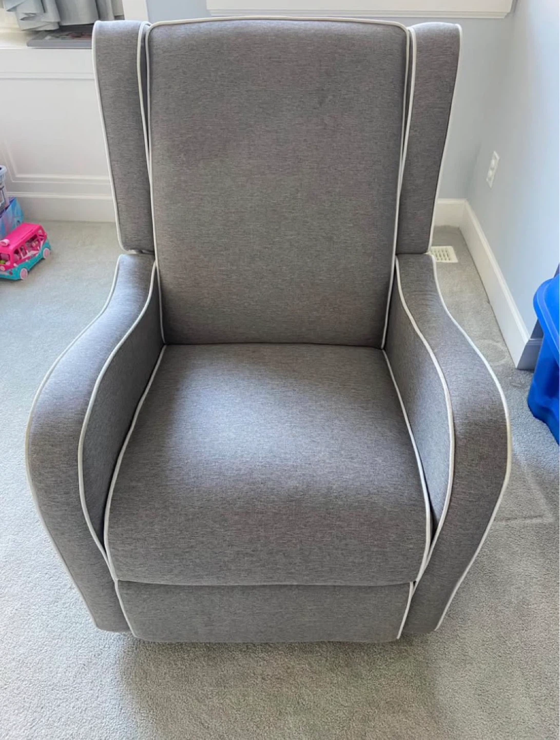 Grey upholstered glider chair with ottoman