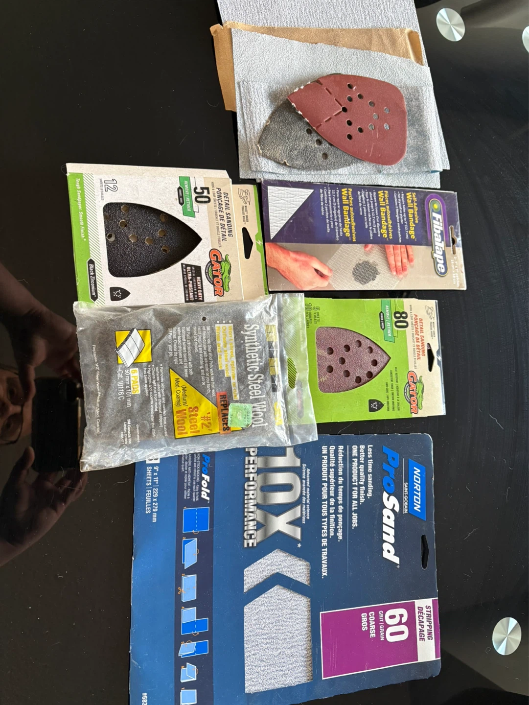 Assorted Sandpaper, Steel Wool, and Wall Bandage