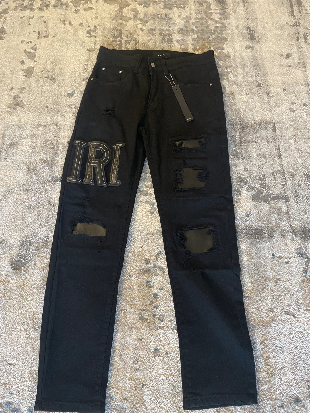 AMIRI Black Ripped Jeans with Logo Patch