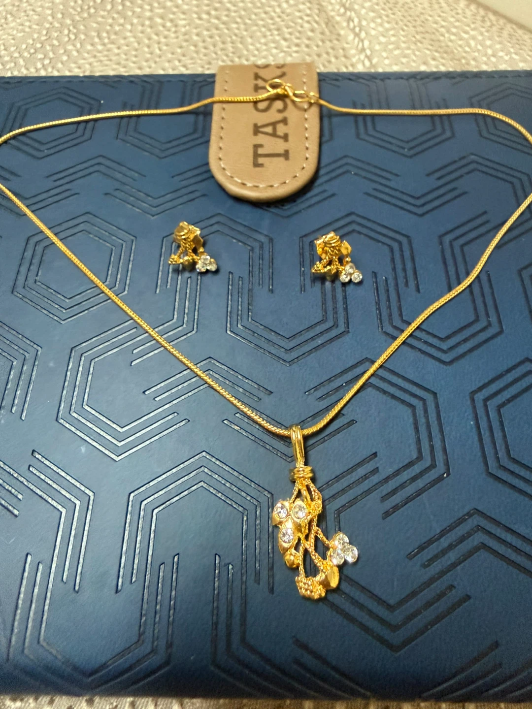 Gold tone necklace and earrings set with clear stones