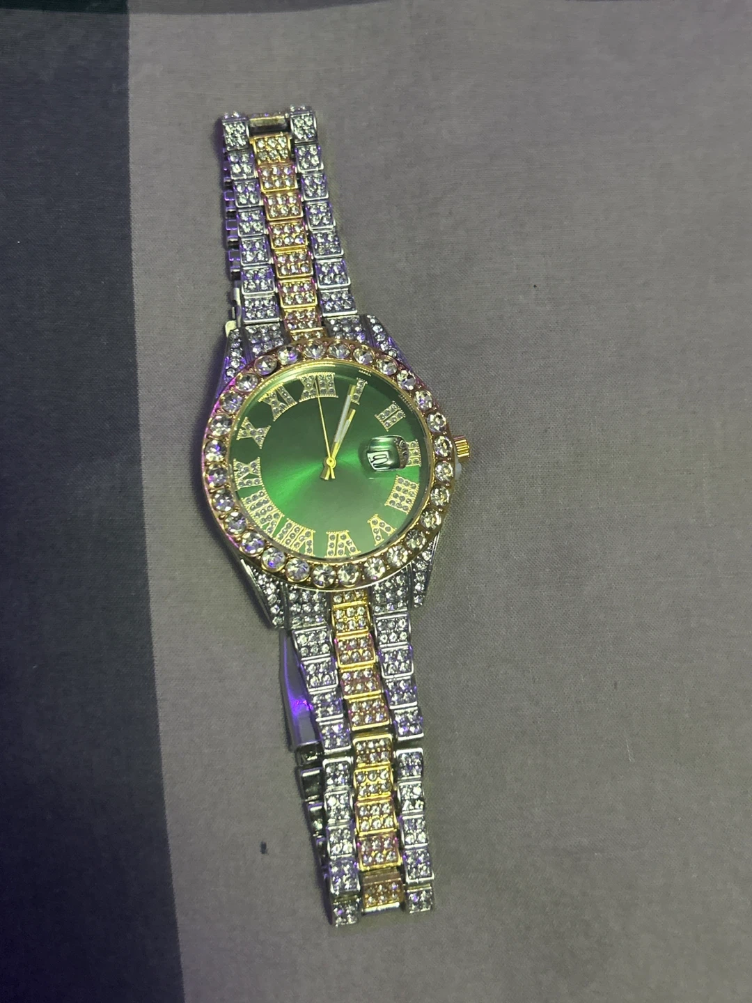 Green face watch with diamond accent band and matching bracelet