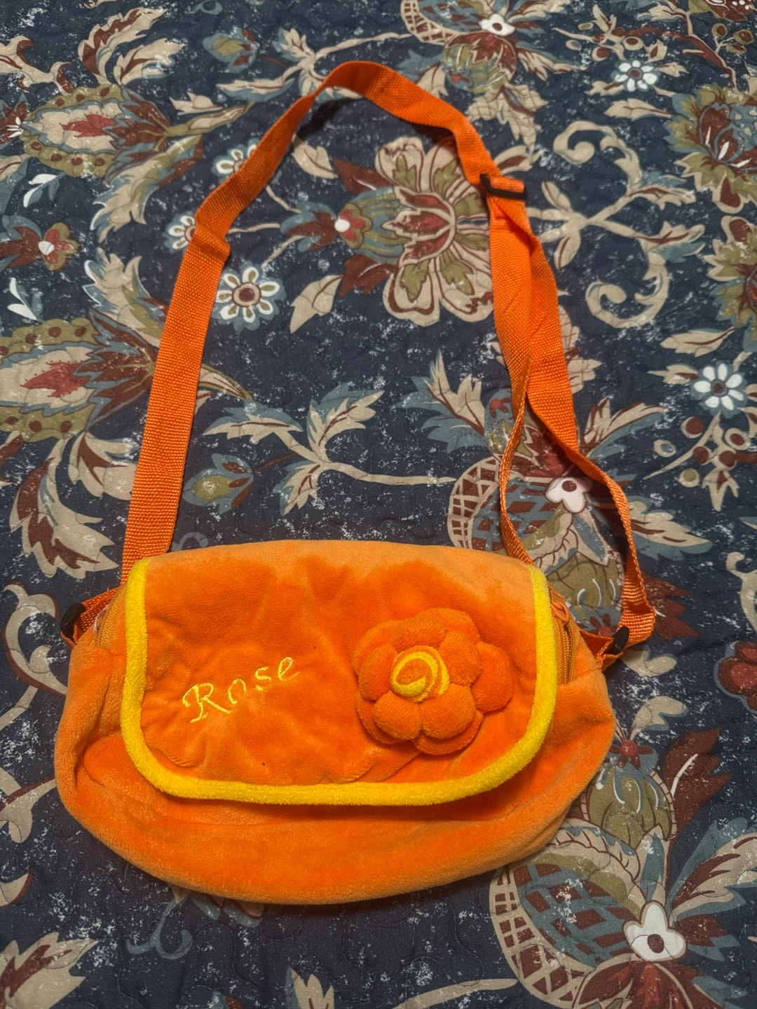 Orange plush purse with flower detail
