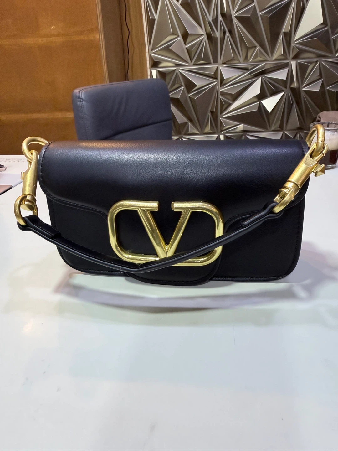 Black Leather Crossbody Bag with Gold 'V' Accent