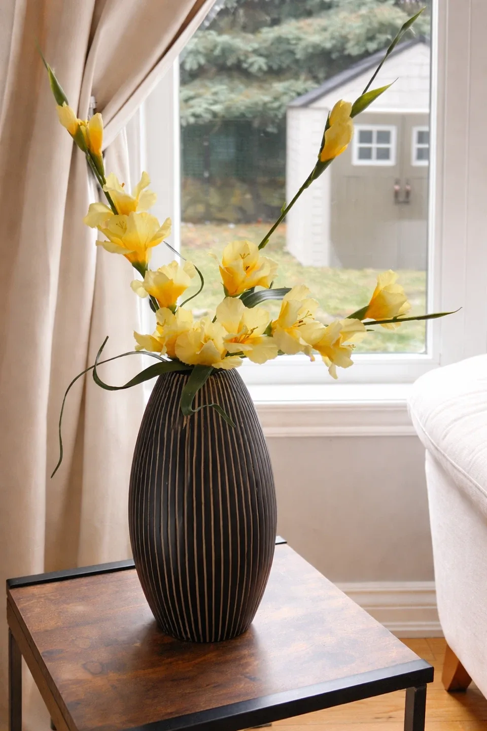 Decorative Yellow Faux Flowers in Striped Vase