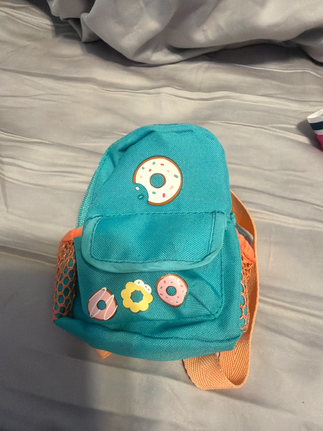 Teal mini backpack with donut decorations