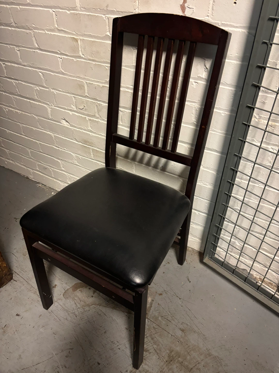 Two Dark Wood Folding Chairs with Black Padded Seat