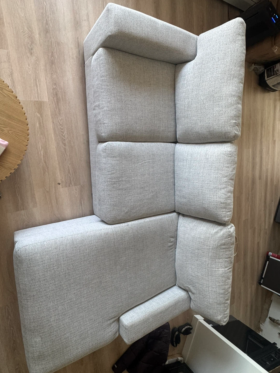 Gray upholstered chaise lounge chair with accent pillows