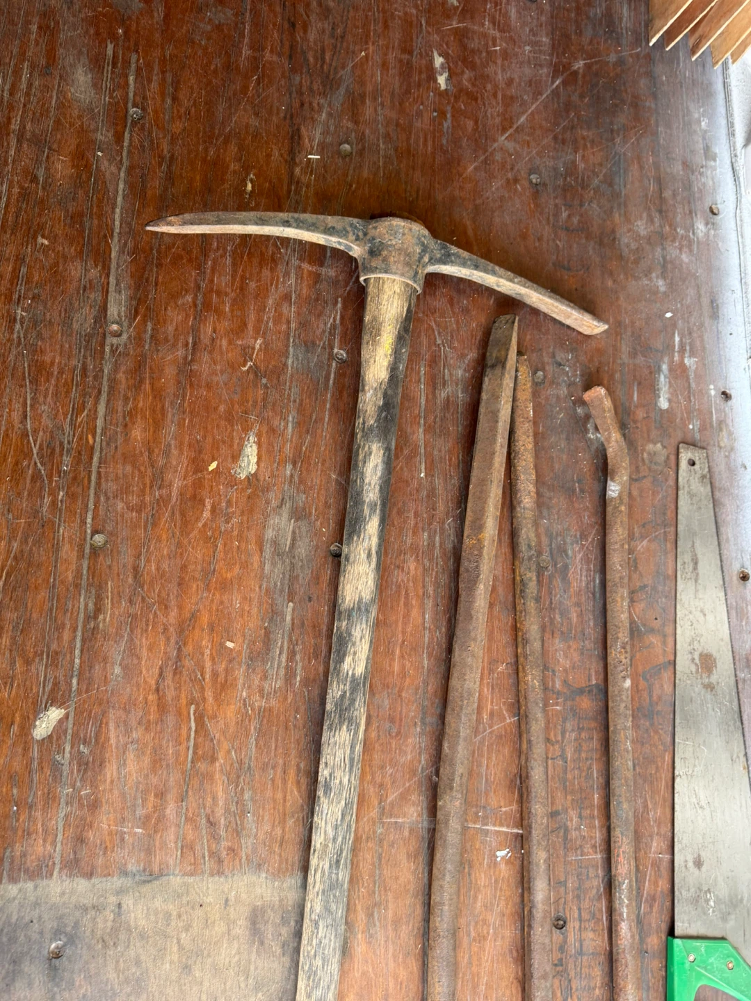 Assorted Hand Tools: Pickaxe, Saw, Pry Bars