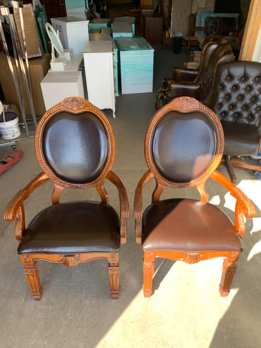 2 Carved Wood Vintage Chairs with Dark Leather Upholstery