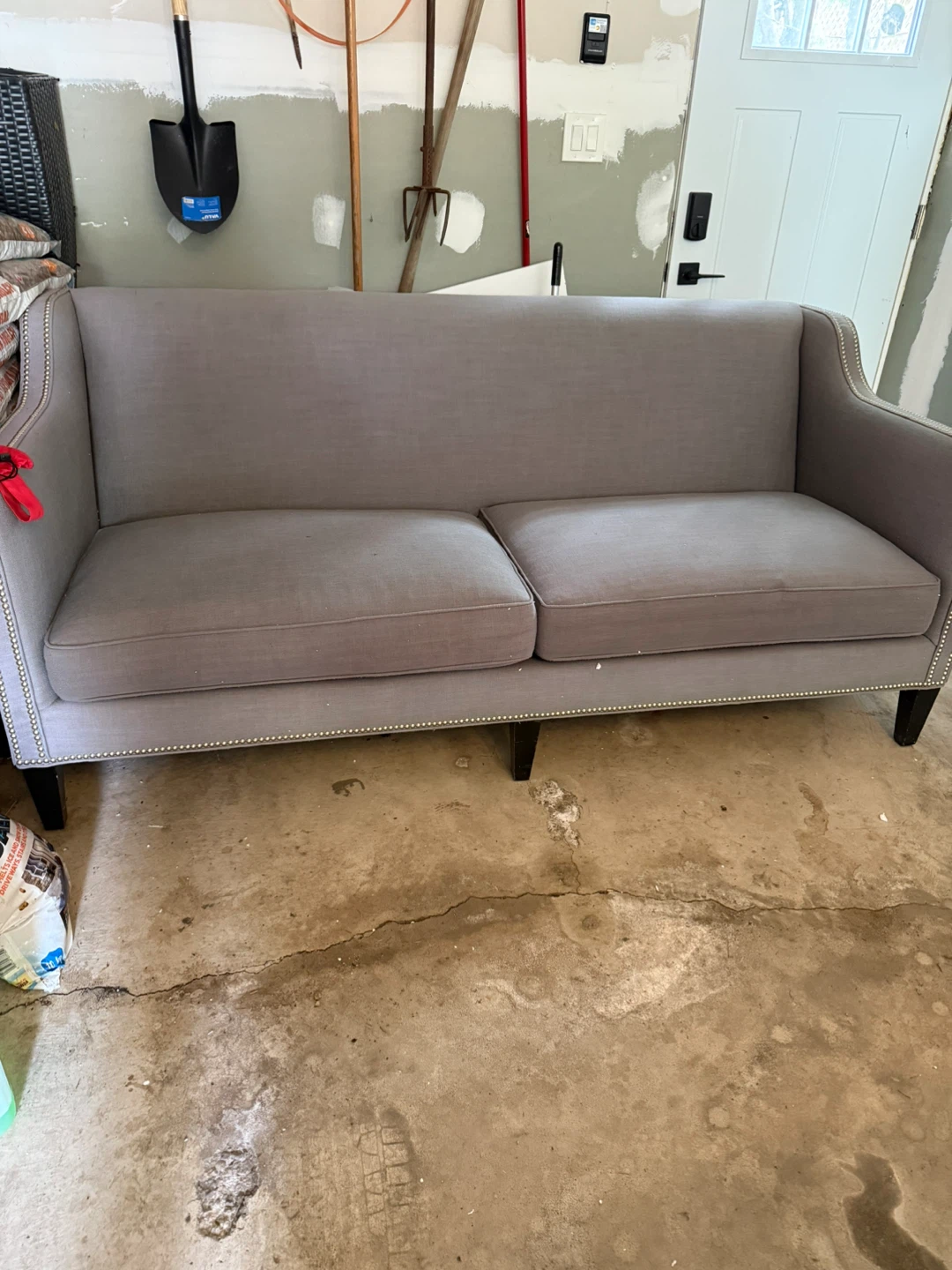 Grey upholstered loveseat with silver nailhead trim - photo 2